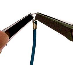 Pliers adding a jump ring to the cord end